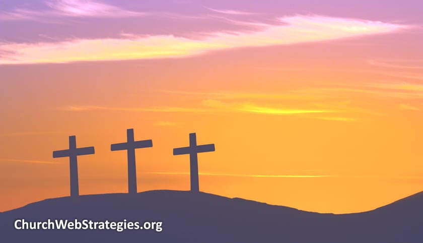 three crosses silhouetted on hill sunset
