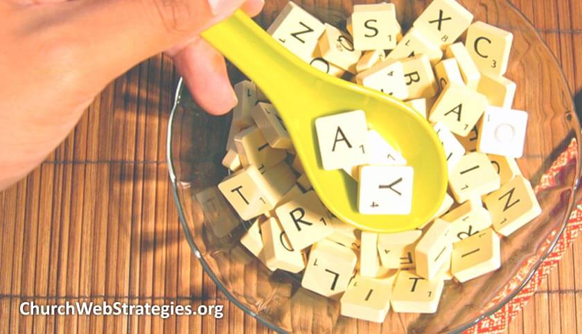 spoon scooping letter tiles out of a bowl