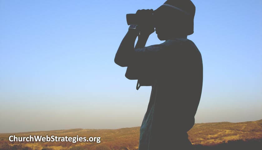 silhouette of person looking through binoculars