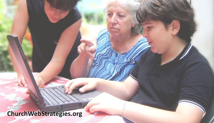 young boys helping grandmother with laptop