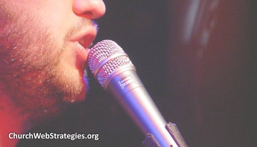 close-up of man singing into microphone